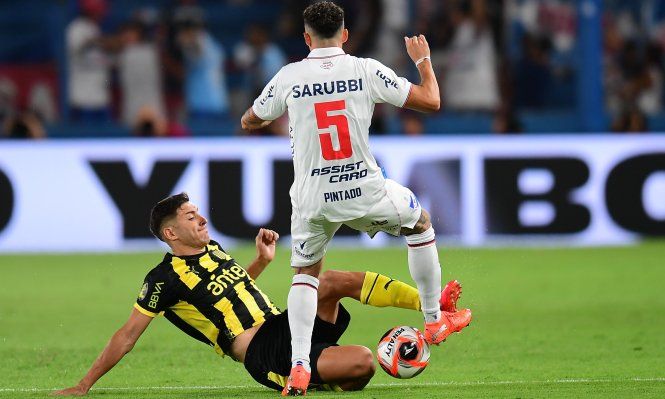 Gastón Togni de Peñarol ante Camilo Cándido de Nacional por el Torneo Apertura