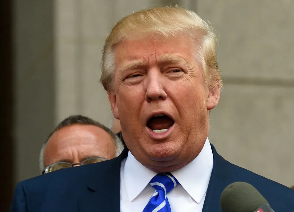 (FILES) This August 17, 2015 file photo shows US presidential candidate Donald Trump as he exits the New York Supreme Court after morning jury duty in New York. Five months before early primary voting, Americas presidential race has devolved into mudslinging, with Republican Donald Trump leading the charge to the bottom by lambasting his many rivals, some of whom are taking the bait and responding in kind. According to the mouthy mogul, Jeb Bush is a mess, Rick Perry should be forced to take an IQ test, and US leaders are stupid. The front-running Trump trolls rivals and others on social media and warns that Mexico is sending rapists and other criminals illegally across the border. AFP PHOTO/DON EMMERT