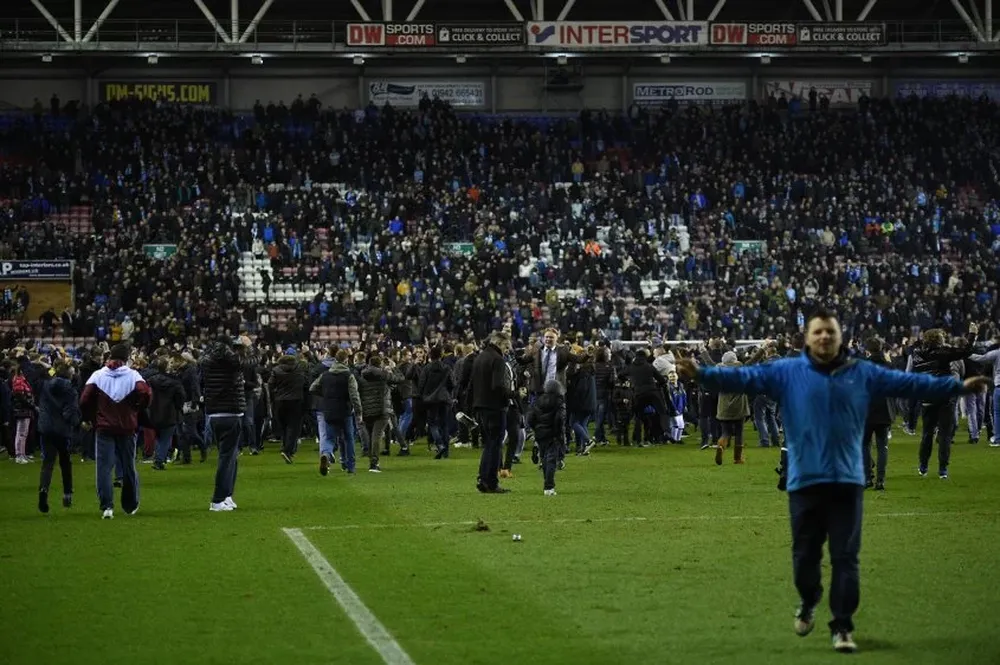 Los hinchas de Wigan invadieron la cancha para festejar el triunfo