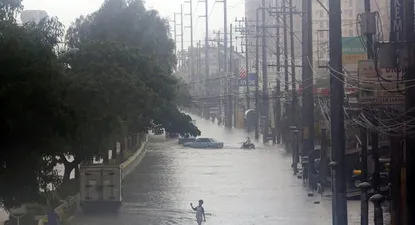 Un niño camina por una calle inundada en Paranque, sur de Manila