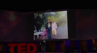 Gebbia en la charla TED con la foto de Artigas y Casciari de fondo