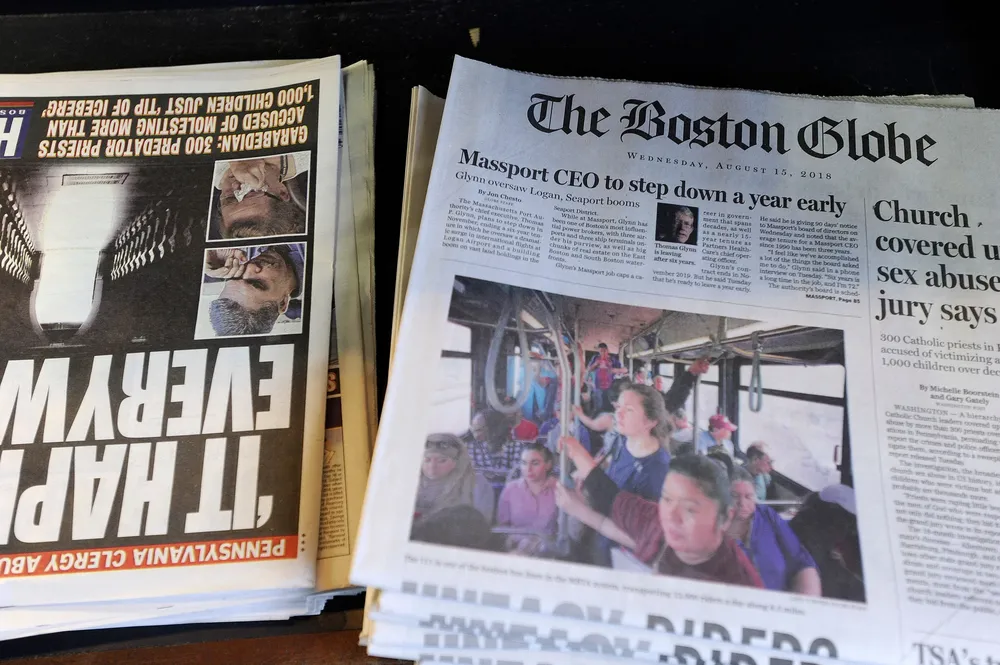 Copies of the Boston Globe sit on the shelf with other daily papers at a newspaper stand at Bostons South Station, August 15, 2018. Branded enemy of the people by us President Donald Trump, the US news media is responding with a campaign aimed at countering the presidents narrative and highlighting the importance of a free press. More than 200 news organizations are to participate in a coordinated campaign on August 16, 2018, with editorials about the importance of an independent media and a social media hashtag #EnemyOfNone. The move comes in response to a call by the Boston Globe amid a growing sense of unease that Trumps rhetoric is harmful to a free press and may even incite violence against journalists.           / AFP / Joseph PREZIOSO