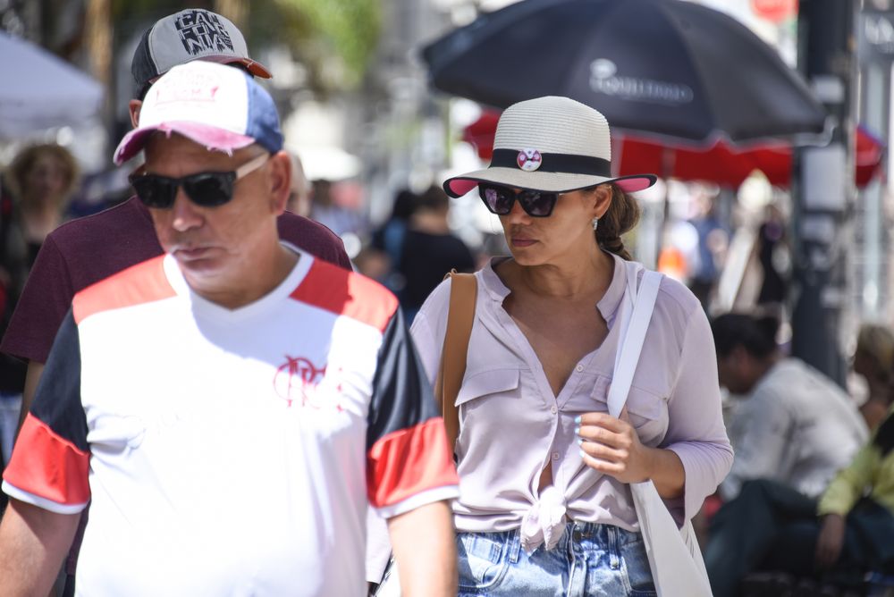 20240201 Calor, verano, estado del tiempo. Gente, personas, turistas caminando usando gorro, sombrero por el sol en Ciudad Vieja.