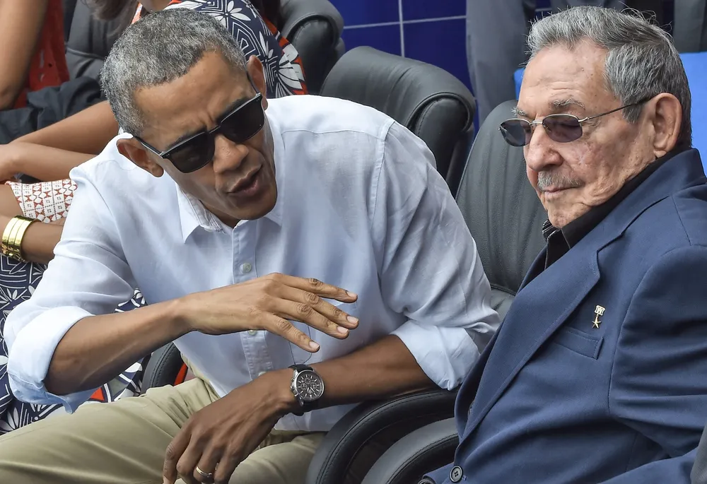 US President Barack Obama speaks next to Cuban President Raul Castro (R) during a Major League baseball exhibition game between the Tampa Bay Rays and the Cuban national team at the Latinoamericano stadium in Havana on March 22, 2016. Obama praised the bravery of Cuban dissidents Tuesday in a meeting at the US embassy in Havana, although opponents back home dismissed the event as a token gesture. AFP PHOTO / Nicholas KAMM