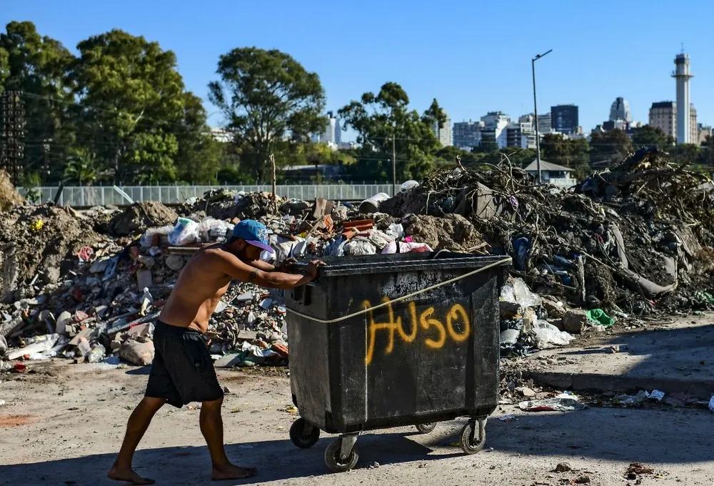 Un hombre empuja un contenedor en una villa de Buenos Aires, Argentina