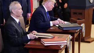 Donald Trump y el viceprimer ministro chino Liu He firmando el acuerdo.