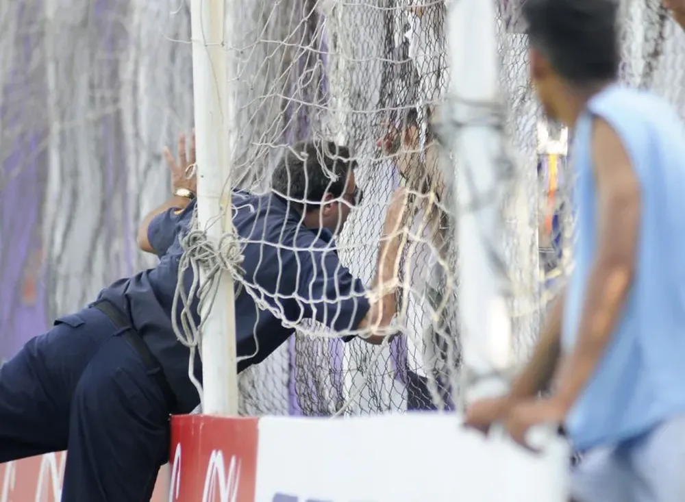 El funcionario del cuerpo de Bomberos, advierte a algunos parciales violetas, ubicados en al tribuna 6 de agogto de 1960, para que apaguen la bengala encendida hacia algunos minutos, los hinchas acataron la orden