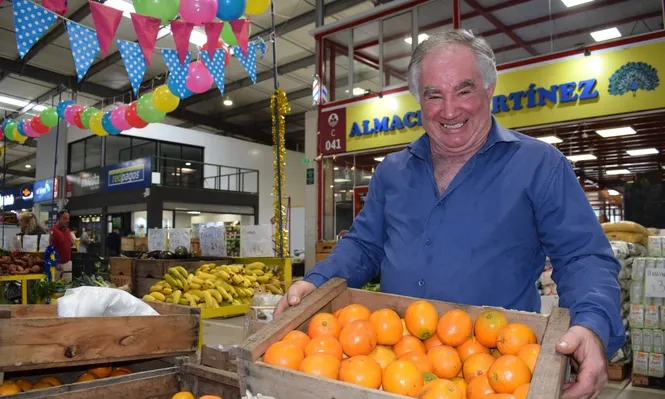El comerciante, en el puesto que tiene delante de su comercio, en la UAM.