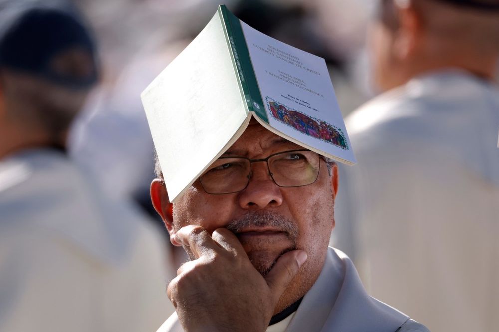 Un sacerdote utiliza su folleto litúrgico para protegerse del sol antes de la Santa Misa oficiada por el Papa León XIV en la Plaza de Cibeles de Madrid el 7 de junio de 2026. Un sacerdote utiliza su folleto litúrgico para protegerse del sol antes de la Santa Misa oficiada por el Papa León XIV en la Plaza de Cibeles de Madrid el 7 de junio de 2026.