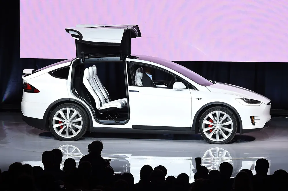 (FILES) In this September 29, 2015 fole photo, the Tesla Model X is presented during a launch event in Femont, California. Tesla on November 24, 2015 began taking orders for its Model X electric sport utility vehicle with a starting price of $80,000. The Model X price can quickly ramp with extras such as self-driving capabilities, more powerful batteries, or ludicrous speed. Model X SUV come in three models and are not expected to ship before the middle of next year. The Model X will be the second electric vehicle that will be coming off the innovative car makers production lines. It is also two years behind schedule. AFP PHOTO/SUSANA BATES
