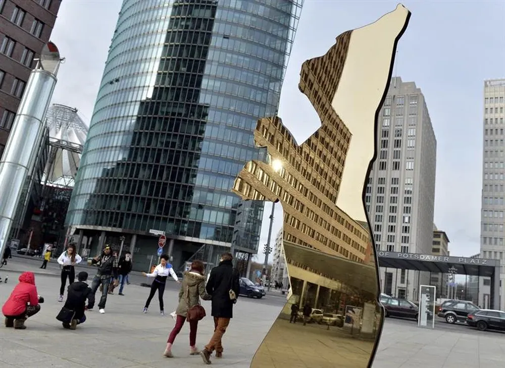 Alemania- Varias personas pasan al lado del logo de la 63 edición del Festival Internacional de Berlín