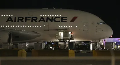 Workers load cargo on an Air France Airbus 380, Flight 65, on the runway at Salt Lake City International Airport after being inspected by the FBI on November 17, 2015 in Salt Lake City, Utah. Two Air France flights bound for Paris from the United States were diverted November 17, 2015 and landed safely after the airline received anonymous bomb threats, the carrier said. Flight 65 from Los Angeles and Flight 55 from Washington were subject to anonymous threats received after their respective takeoff, the airline said in a statement. AFP PHOTO / GEORGE FREY