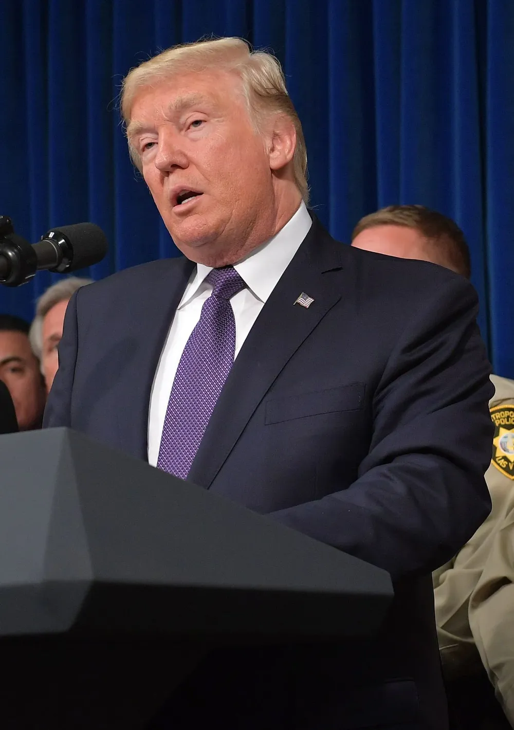US President Donald Trump speaks as he visits the Metropolitan Police Department command centre in Las Vegas, Nevada on October 4, 2017.                     President Donald Trump was in Las Vegas to meet shooting victims and first responders, as investigators question the girlfriend of gunman Stephen Paddock for clues to what drove him to mass murder. / AFP / MANDEL NGAN