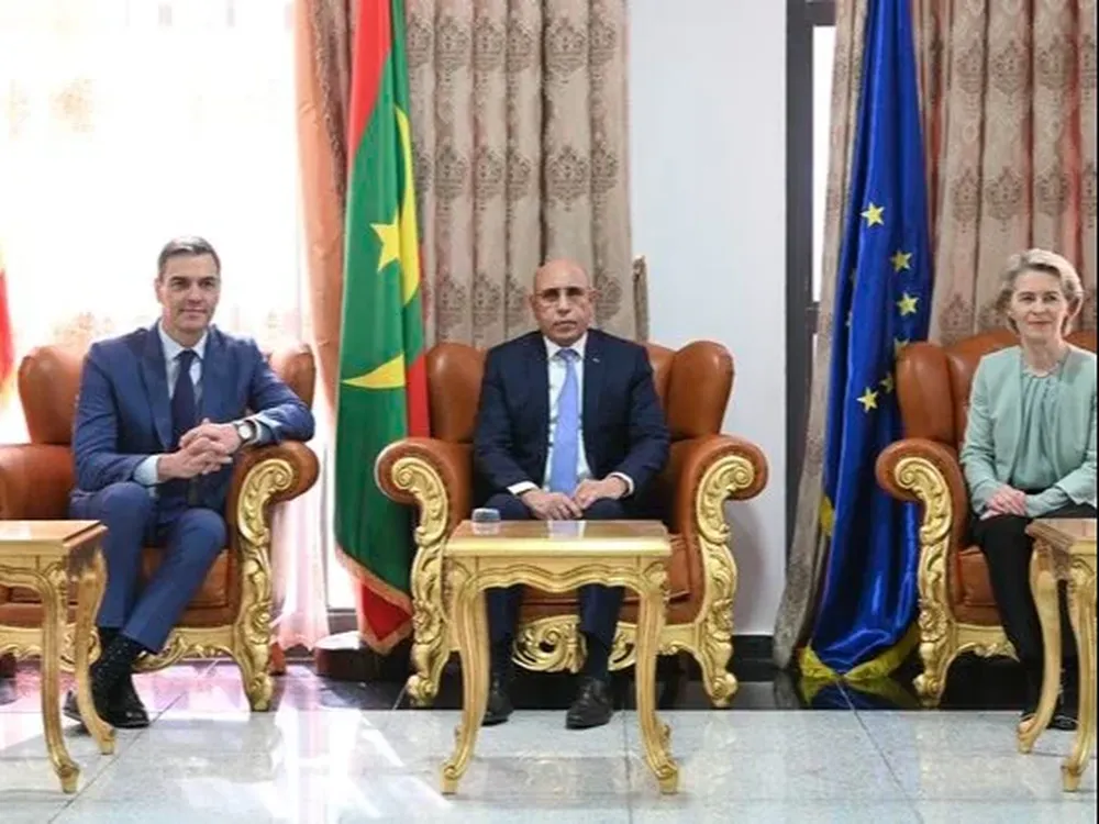 España destinará en los próximos años más de 300 millones de euros al desarrollo económico de Mauritania y para que este país haga frente a la migración irregular que parte de sus costas y que está provocando una incesante llegada de cayucos a Canarias. Esa ayuda ha sido avanzada por el presidente del Gobierno, Pedro Sánchez, en una declaración junto a la presidenta de la Comisión Europea, Ursula von der Leyen, y el presidente de Mauritania, Mohamed Ould Ghazouani. Sánchez se encuentra de visita a Nuakchot con Von der Leyen con el fin de reforzar la colaboración bilateral y de la UE con Mauritania en un momento de escalada de la migración irregular. España, y Canarias en concreto, está sufriendo esa presión migratoria y Mauritania es, según datos del Gobierno, el origen del 83 % de los cayucos que llegan a sus costas. No sólo a ese problema se ha referido Sánchez en su intervención, pero sí ha sido uno de los elementos principales y está en el fondo de la ayuda integral que se va a prestar al país. Tal y como había avanzado poco antes en un foro sobre hidrógeno verde organizado con motivo de su visita y la de Von der Leyen, en los próximos cinco años se pondrán 200 millones de euros a disposición de proyectos de viabilidad, financiación de proyectos específicos y seguros de créditos. Se hará énfasis especial en proyectos verdes y en inversiones en energías renovables. Además, ha anunciado un aumento de los instrumentos de cooperación al desarrollo. Ha explicado que se ha firmado el nuevo Acuerdo Marco País que está alineado con la estrategia mauritana para el crecimiento acelerado y la prosperidad compartida. Este nuevo acuerdo, ha dicho, prevé 60 millones de euros para proyectos de desarrollo en los cuatro próximos años. Adicionalmente, destinará 50 millones de euros más en los próximos cinco años a nuevos proyectos de cooperación financiera. Sánchez ha precisado que ya se está trabajando con el Banco Mundial para identificar proyectos específicos cofinanciados en los ámbitos de energías renovables e infraestructuras y se espera que haya pronto avances en estos campos. Ha sumado a todo ello el hecho de que España vaya a doblar su ayuda humanitaria al país, incrementando del millón de euros dedicado en 2023 a dos millones este año. El presidente del Gobierno ha justificado ese aumento por el impacto en Mauritania que están provocando los conflictos en Mali y Níger y que están ocasionando un significativo incremento del número de refugiados y dando lugar a una situación que ha calificado de preocupante. Por tanto, las ayudas cuantificadas por Sánchez para los próximos años llegan a los 312 millones de euros, pero junto a esas medidas ha afirmado que España reforzará la cooperación destinada a tratar la presión migratoria. Fortaleceremos nuestros proyectos de colaboración ya existentes, relativos a control fronterizo, y exploraremos posibles fórmulas para facilitar la migración regular, ha señalado. En ese sentido, ha comunicado que ya se está hablando entre los gobiernos de España y Mauritania sobre proyectos de migración circular como los que ya se han puesto en marcha con otros países y ha reiterado su defensa de garantizar flujos migratorios ordenados y seguros. Todas estas medidas confía que mejoren la presión migratoria que está sufriendo Canarias, según ha comentado en una breve conversación informal con los periodistas que cubren su viaje a Mauritania. Sánchez ha recalcado que el objetivo claro de la visita a Mauritania junto a Von der Leyen es fortalecer la cooperación con el país. Nuestro objetivo común debe ser la consecución de un desarrollo sostenible e inclusivo en Mauritania. Ese debería ser también el objetivo para la Unión Europea y España, porque la prosperidad en Mauritania es la mejor inversión hacia la estabilidad y la seguridad en esta región, ha dicho refiriéndose al Sahel. El presidente del Gobierno ha aludido también a la cooperación cultural, en cuyo contexto ha anunciado que España va a abrir una extensión del Instituto Cervantes en Nuakchot atendiendo a la solicitud que en ese sentido habían hecho las autoridades mauritanas. Presidente Ghazouani -ha subrayado Sánchez-, le puedo asegurar que puede contar con España como amigo y como socio estratégico a largo plazo