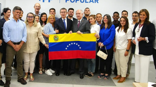 Alberto Núñez Feijóo posa junto a una bandera venezolana