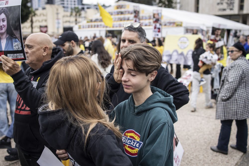 Familiares y amigos de rehenes israel&iacute;es retenidos por militantes de Hamas en la Franja de Gaza reaccionan mientras observan la liberaci&oacute;n de cuatro mujeres soldados, en una pantalla en la plaza de rehenes en Tel Aviv el 25 de enero de 2025.