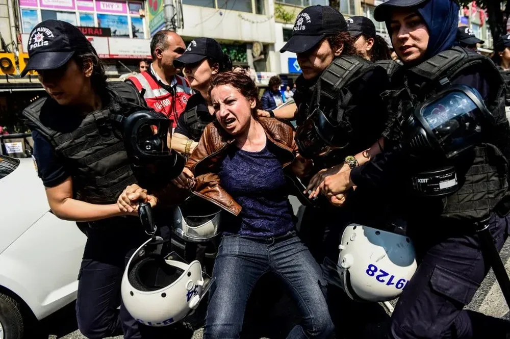Policía turca arresta a una manifestante por desafiar la prohibición de marchar en la plaza Taksin, en Estambul, para conmemorar el primero de mayo