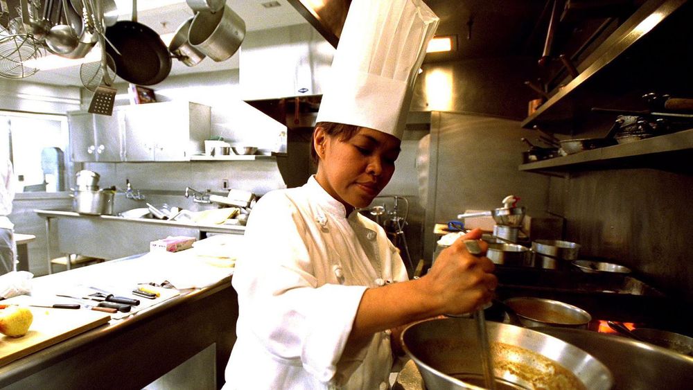La chef Cristeta Comerford preparando una comida en la Casa Blanca en 2002, antes de hacer historia al alcanzar el cargo máximo en esa cocina.