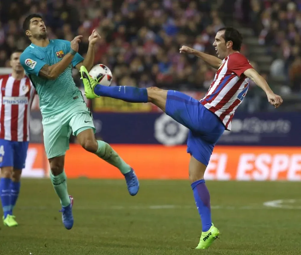 Luis Suárez y Diego Godín