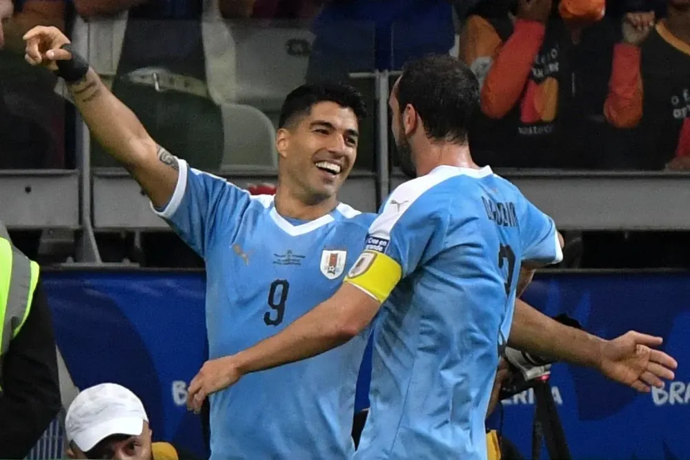 Luis Suárez y Diego Godín
