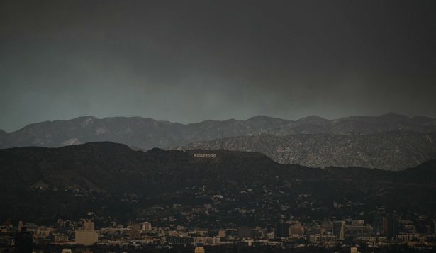 El letrero de Hollywood se ve a lo lejos, mientras el cielo se ve envuelto en un oscuro humo proveniente de los numerosos incendios que arden alrededor de Los Ángeles