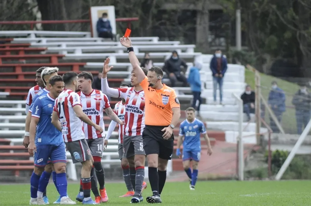 Diego Riveiro le muestra la tarjeta roja a Bergessio por su falta al final del partido
