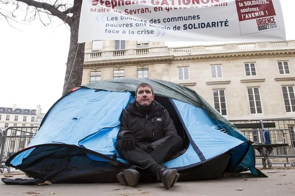 Francia- El alcalde de Sevran, Stéphane Gatignon, posa en la entrada de su tienda desde donde hace huelga de hambre