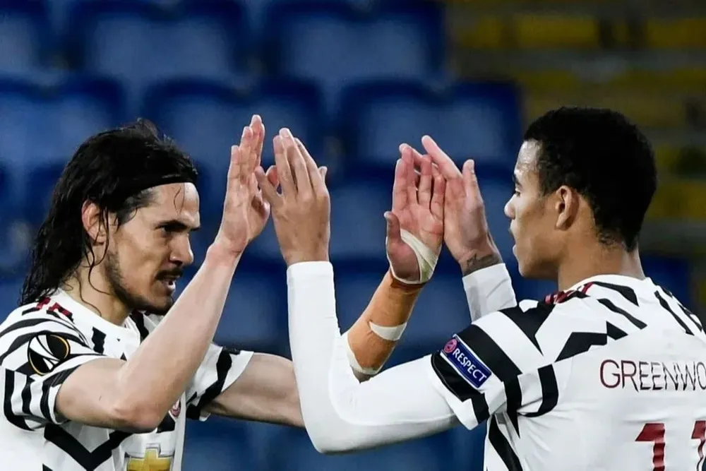 Edinson Cavani y Mason Greenwood en Manchester