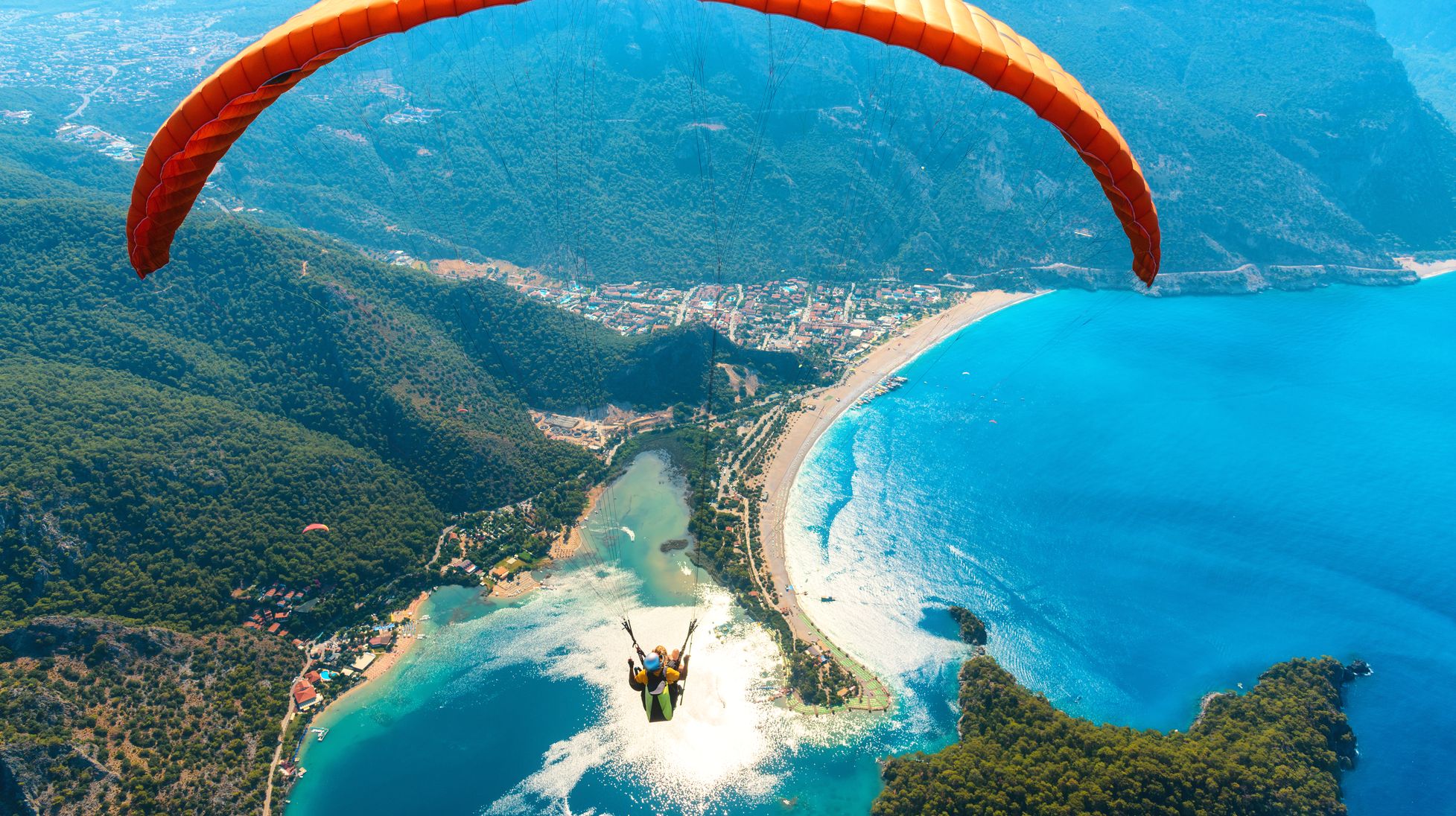 paraglider-tandem-flying-over-the-sea-with-blue-wa-2023-11-27-05-34-15-utc.jpg