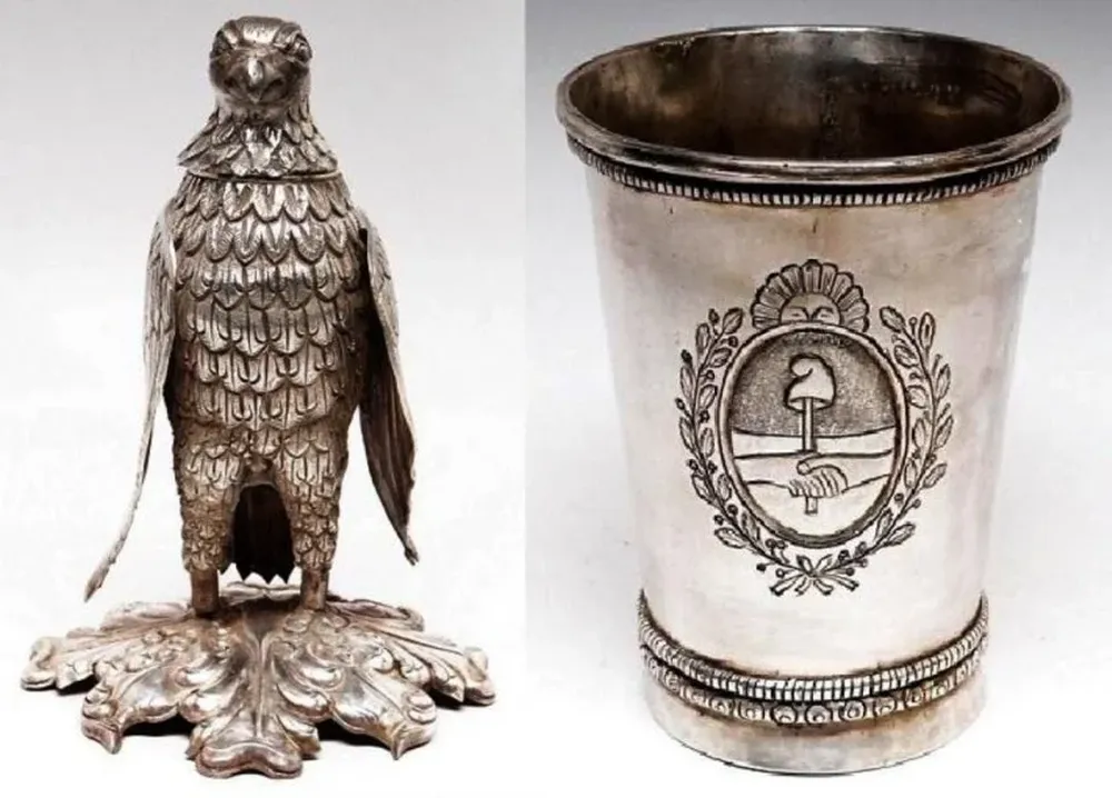 Un mate de plata colonial Chile en forma de águila, con fino cincel y labrado sobre base labrada y cincelada -peso: 640 grs-. (siglo XIX) y una jarra de plata colonial, lisa con guardas perladas, burilado, cincelado y labrado con la imagen del escudo argentino -peso: 535 grs.- (siglo XIX).