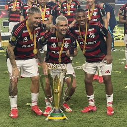 Guillermo Varela, Giorgian De Arrascaeta y Nicolás De la Cruz celebran el título de la Supercopa Brasileña con Flamengo; De Arrascaeta sostiene en su mano izquierda el teléfono en el que aparece Matías Viña en una video llamada, para que no se perdiera la celebración