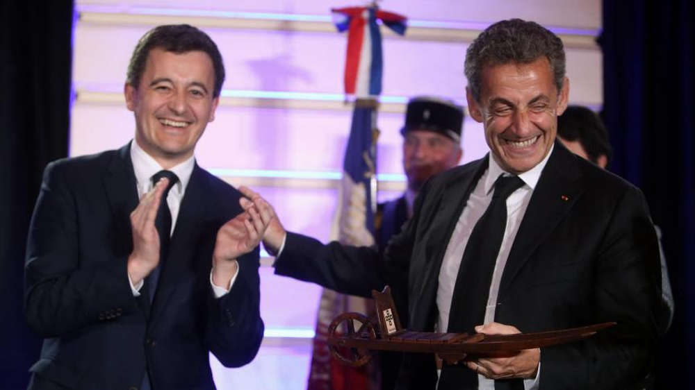 El ministro de Justicia francés, Gerald Darmanin y el expresidente Nicolás Sarkozy.