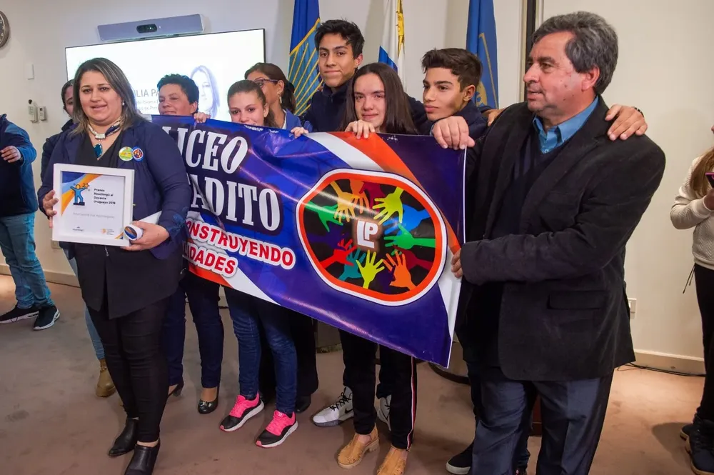 Cecila Paz junto a sus alumnos del liceo Pintadito de Artigas recibe la premiación de la fundación Reaching U