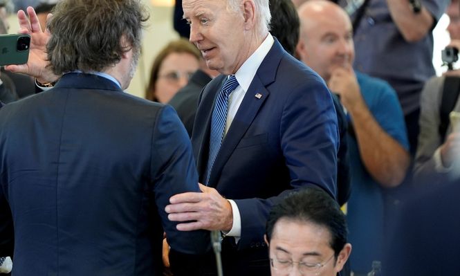 El presidente Javier Milei saluda a su par estadounidense Joe Biden&nbsp; mientras el embajador Gerardo Werthein los fotografía este viernes en el G7
