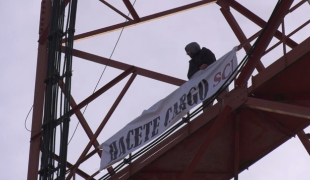 El hombre que trepó a la torre de Antel en Florida y su pancarta