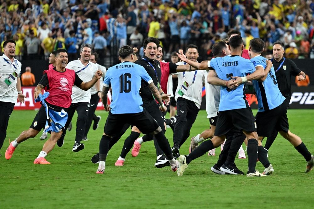 20240707 FBL-COPA AMERICA-2024-URU-BRA Uruguays midfielder #05 Manuel Ugarte (L), Uruguays defender #03 Sebastian Caceres (C) and Uruguays defender #16 Mathias Olivera celebrate alongside teammates their teams vicotry in the Conmebol 2024 Copa America