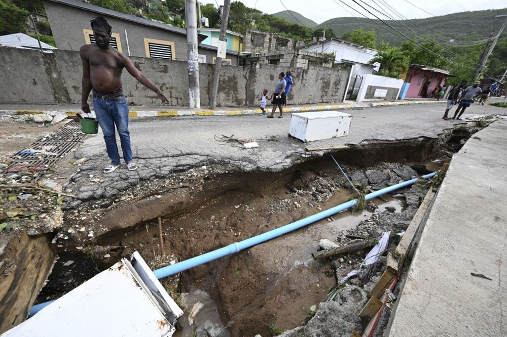 Residents look at a damaged drain in Shooters Hill, Jamaica, in the aftermath of Hurricane Beryl on July 4, 2024. Beryl powered towards Mexico and the Cayman Islands early on July 4, threatening strong winds and a storm surge after battering Jamaicas sou