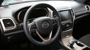 MIAMI, FL - JULY 24: The interior of a Fiat Chrysler Jeep Grand Cherokee is seen on a sales lot as the company announced it is recalling about 1.4 million Dodges, Jeeps, Rams and Chryslers vehicles equipped with certain radios on July 24, 2015 in Miami, Florida. The recall was announced after hackers were able to manipulate remotely a Jeep Cherokees computer software.   Joe Raedle/Getty Images/AFP== FOR NEWSPAPERS, INTERNET, TELCOS & TELEVISION USE ONLY ==