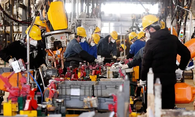 Los empleados trabajan en una línea de ensamblaje de una fábrica de Wuling Motors en Qingdao.