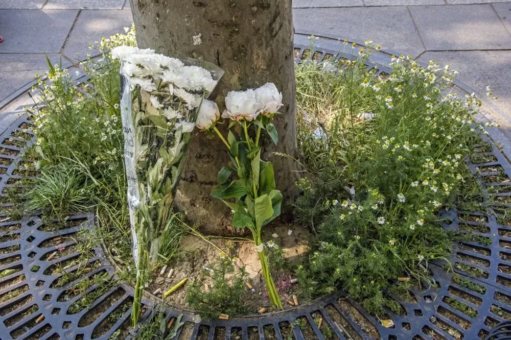 Ramos de flores descansan en el lugar en el que fue asesinado un policía durante un ataque yihadista perpetrado en la avenida de los Campos Elíseos de París