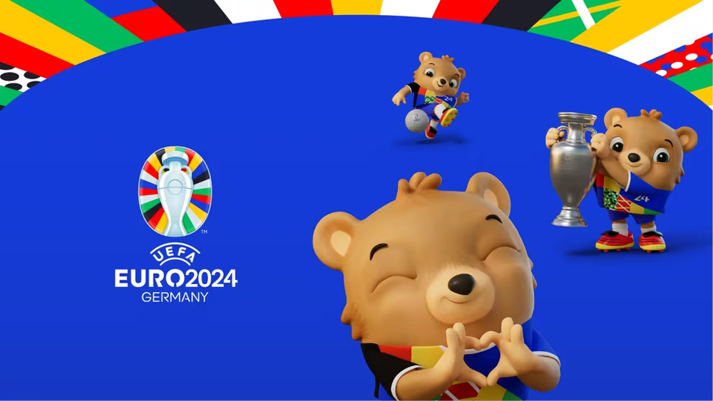 Albärt, el oso amigable y carismático, vestido con los vibrantes colores de Alemania, listo para dar la bienvenida a los equipos y aficionados al espectáculo futbolístico de la Eurocopa 2024. &nbsp;