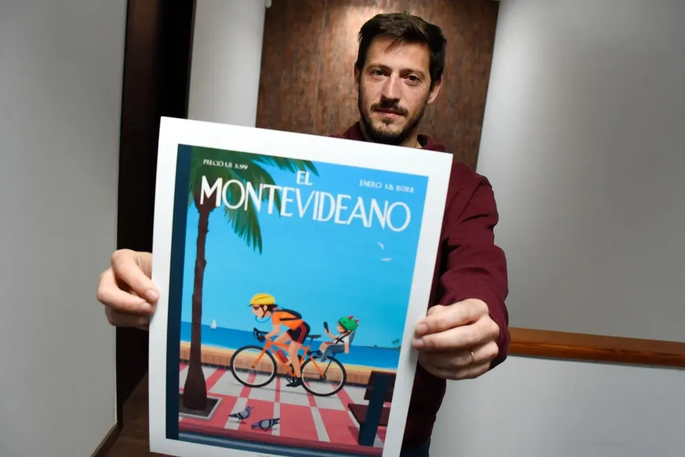 El ilustrador Fonchi Rosso en su estudio en Pocitos con la primera portada ficticia de El Montevideano en Instagram