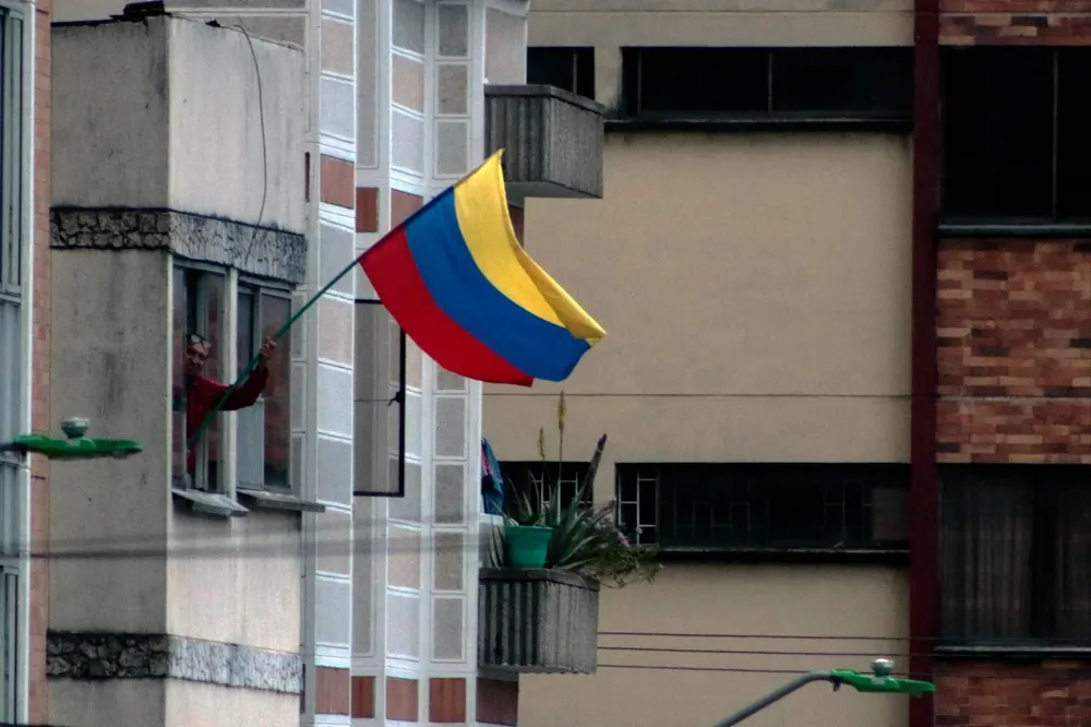 Un hombre agita una bandera colombiana en Bucaramanga, tras los resultados de la primera ronda de las elecciones