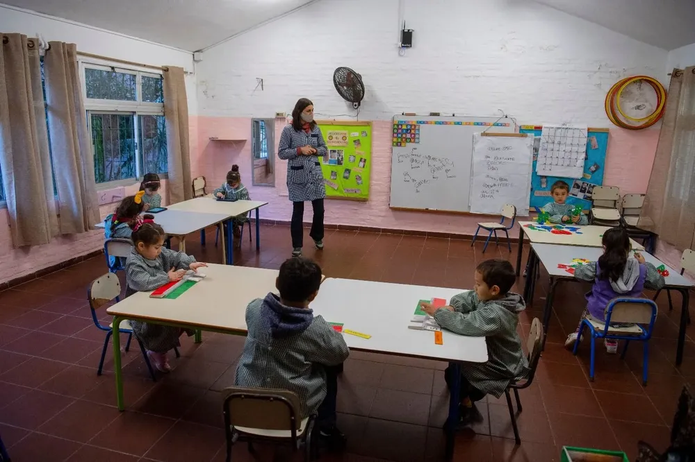 Los niños y maestros utilizan la computadora en el aula.